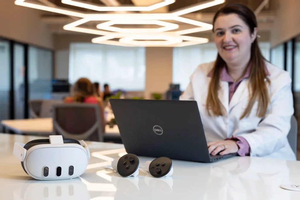 Unimed: médica sorridente com notebook e óculos de realidade virtual
