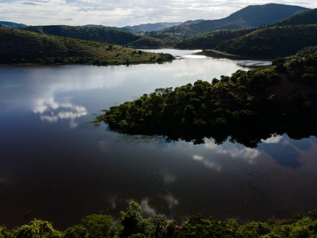 Mina do Cruzeiro: represa entre morros cobertos de mata vista do alto